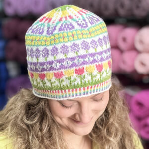 Woman wearing floral knit hat.